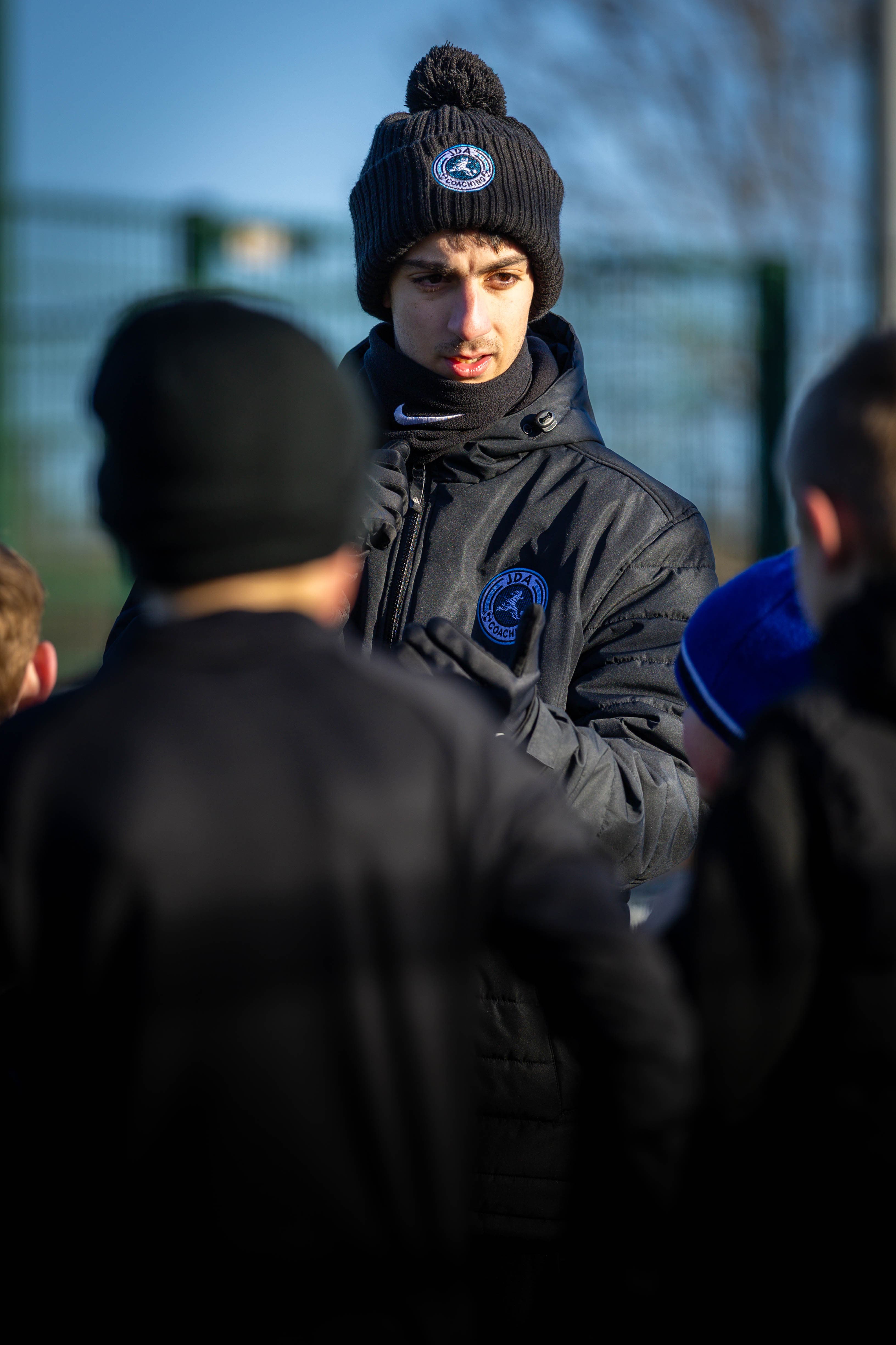 A JDA coach giving a player individual coaching attention