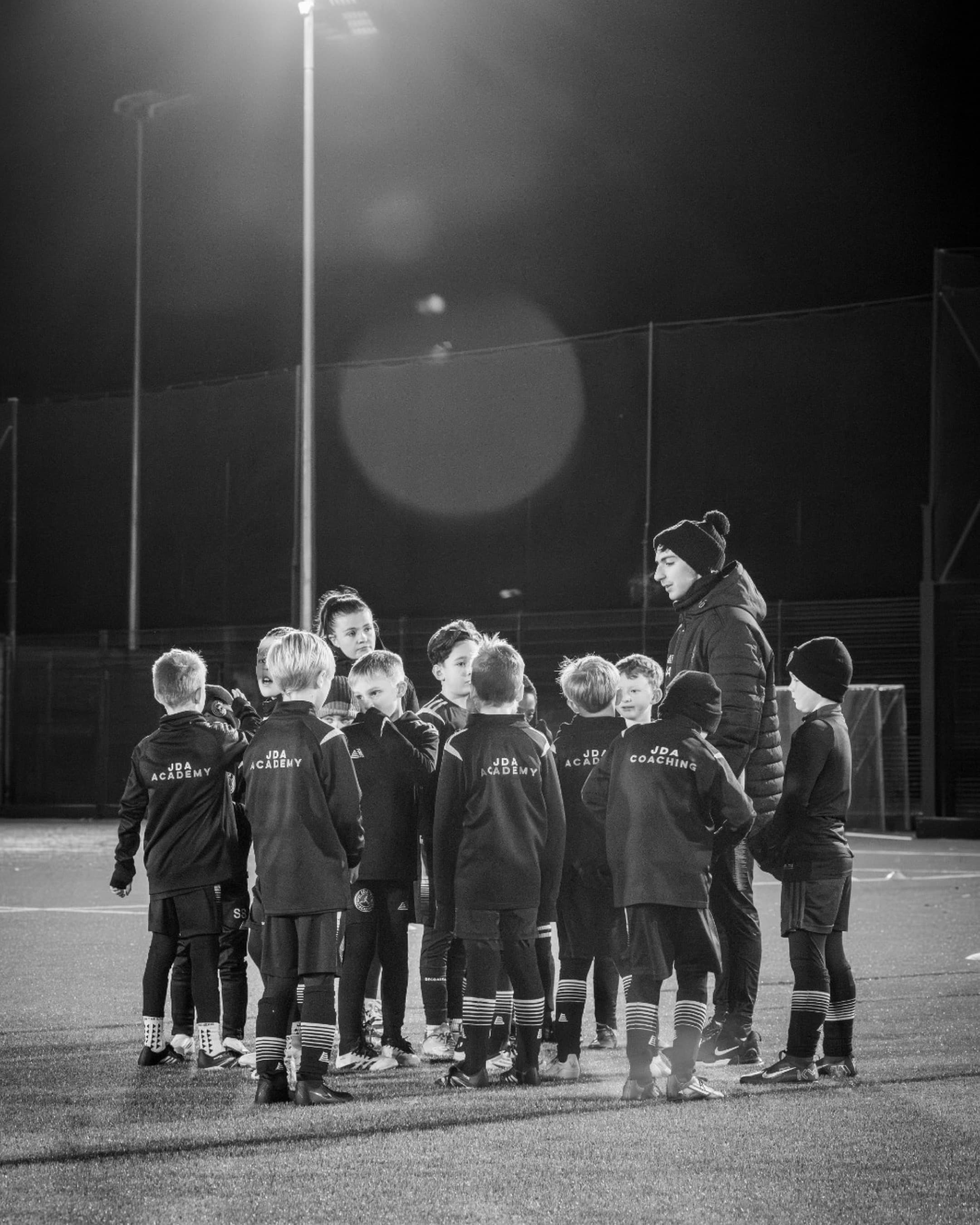 A JDA Blacks squad player winning a 1v1 duel on the touchline