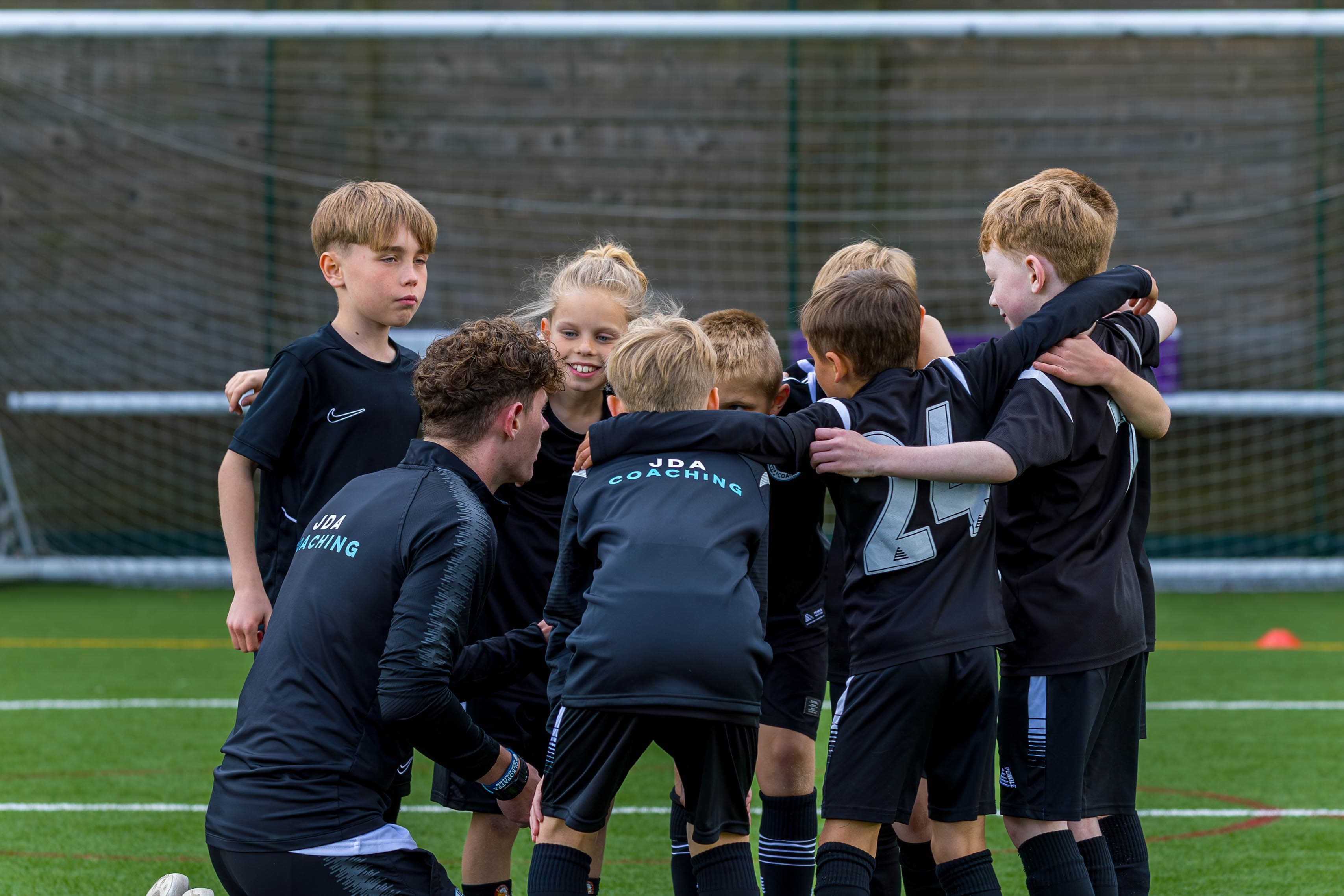 A JDA coach working with players during a session